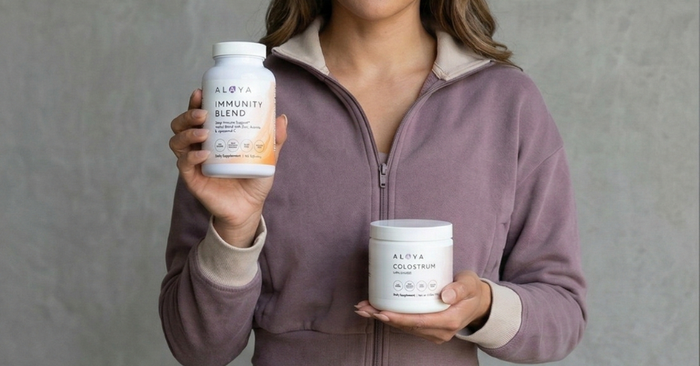 woman holding Alaya Immunity Support and colostrum