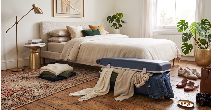 suitcase on floor with clothe pouring out