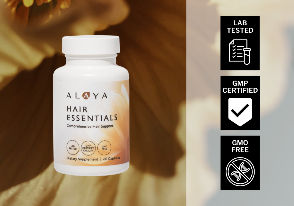 Alaya Hair Essentials supplement bottle with certification icons on a blurred natural background. Lab Tested, GMP Certified, GMO Free